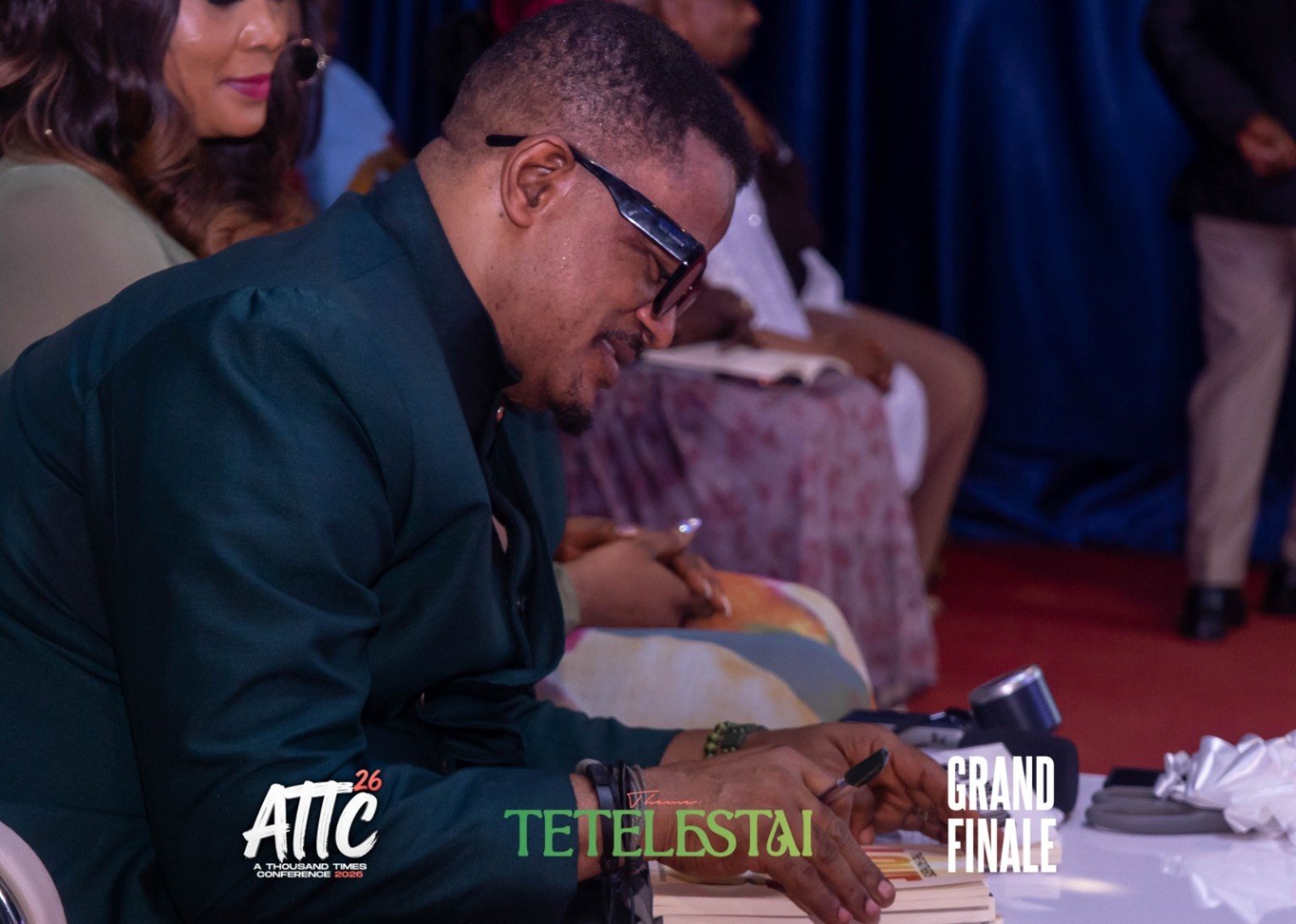 Pastor Barnabas Okunola signing the newly launched books